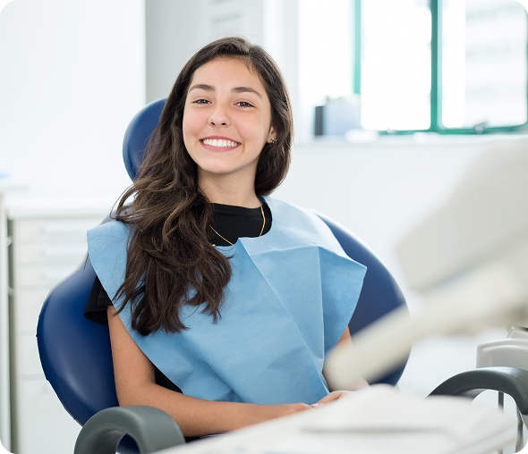 Teenage girl smiling in dental chair