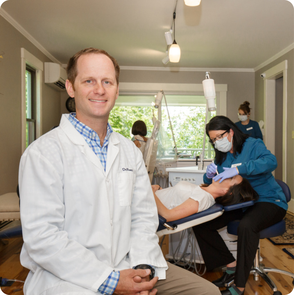 Dentist and dental team treating patient in clinic