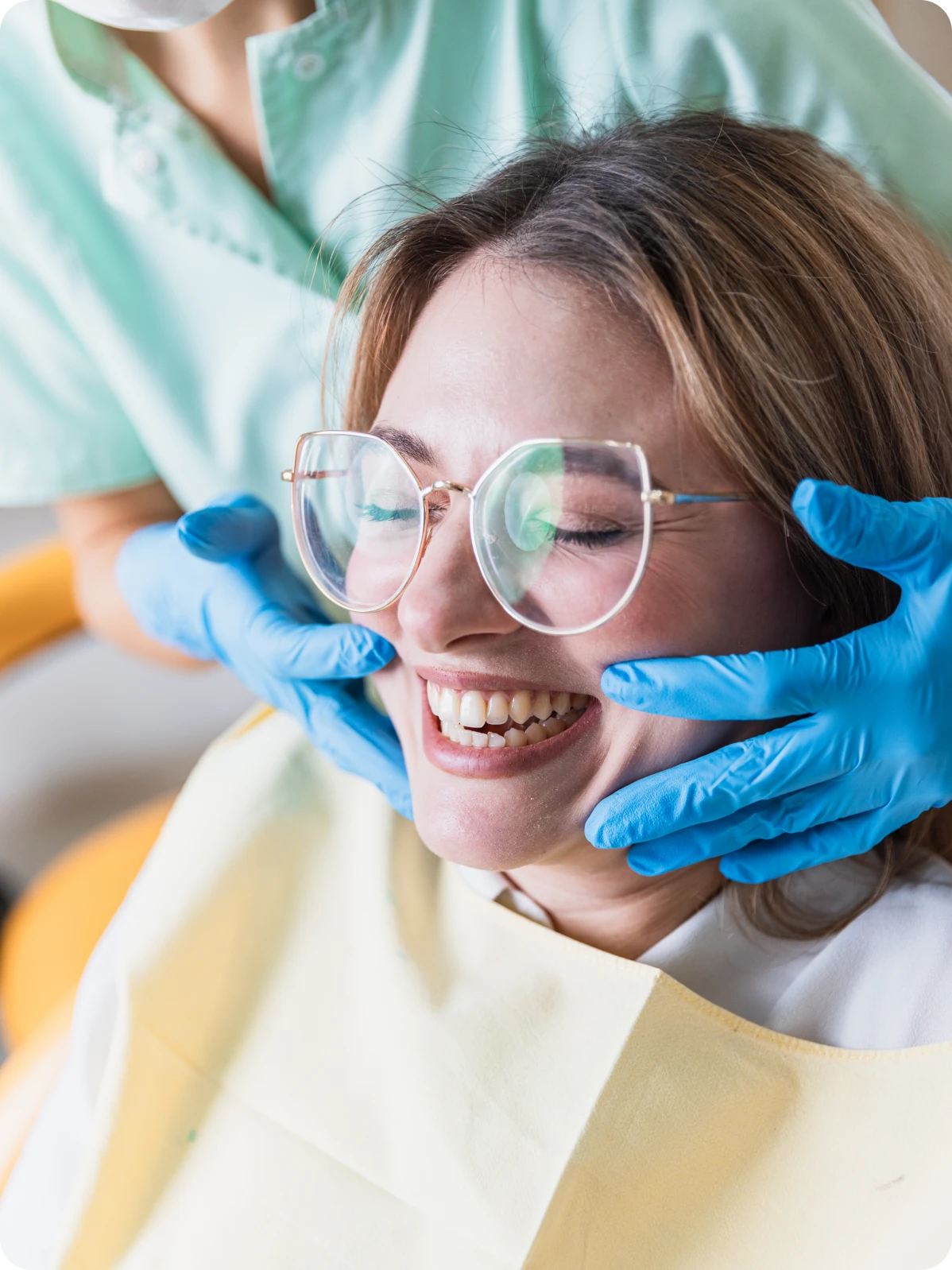 Smiling dental patient wearing glasses in chair